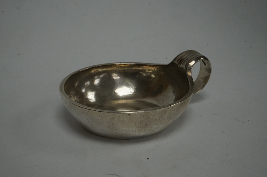 A late 18th/early 19th century French white metal taste vin, makers mark GI below a crown stamped three times, diameter 85mm, 125 grams. Condition - fair